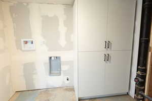 Laundry area featuring unfinished concrete flooring and hookup for a washing machine