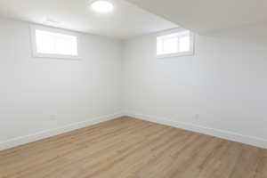 Below grade area featuring wood finished floors and baseboards