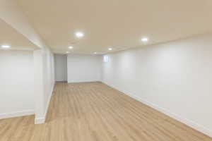 Basement featuring light wood finished floors and recessed lighting