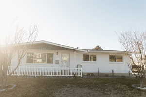 View of front facade featuring brick siding and a porch