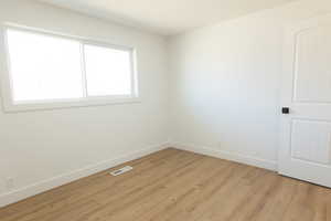 Unfurnished room featuring light wood-style flooring
