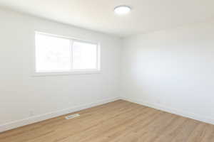 Spare room featuring light wood finished floors