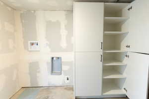 Laundry area with hookup for a washing machine and concrete flooring