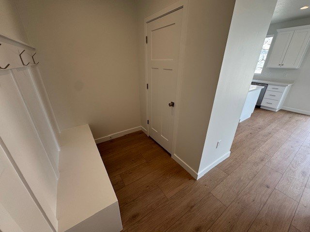 Hallway with light wood finished floors and baseboards