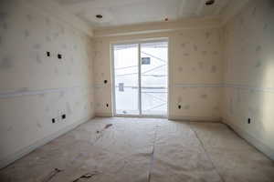 Unfurnished room with wallpapered walls