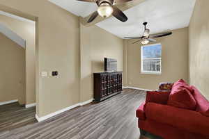 Living room with wood finished floors and ceiling fan