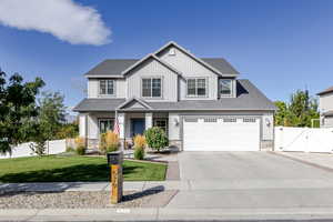 View of front of property with a gate, a porch, roof with shingles, and driveway