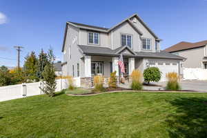 Craftsman-style house with a gate, a porch, stone siding, a garage, and concrete driveway
