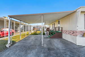 View of parking featuring a carport