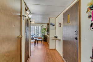 Hallway with light wood-style floors