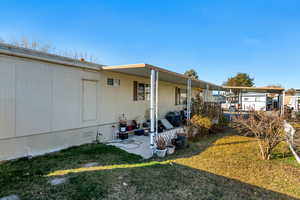 Back of property featuring a patio, a yard, and crawl space
