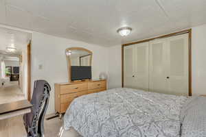 Bedroom featuring light colored carpet and a closet