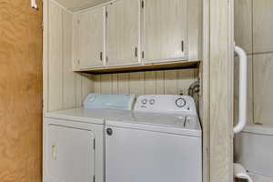 Laundry area featuring washer and dryer and cabinet space