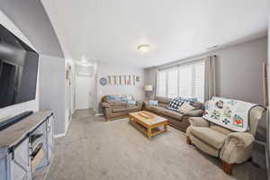 Living room with light carpet and baseboards