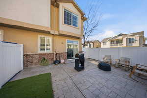 Fenced backyard featuring a grill, a patio, and a residential view