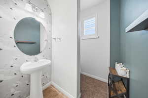 Bathroom with baseboards and tile patterned flooring