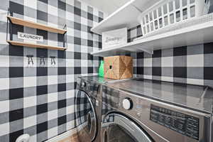 Laundry area with washing machine and clothes dryer