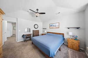 Bedroom featuring lofted ceiling, ceiling fan, and carpet flooring