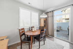 Dining area featuring baseboards and tile patterned flooring
