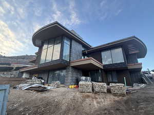 Back of property with stone siding