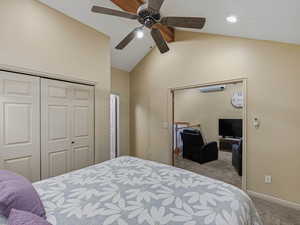 Bedroom with vaulted ceiling, carpet floors, a closet, recessed lighting, and a ceiling fan