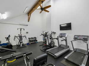 Exercise room featuring ceiling fan and lofted ceiling