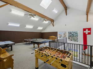 Game room featuring a ceiling fan and a skylight