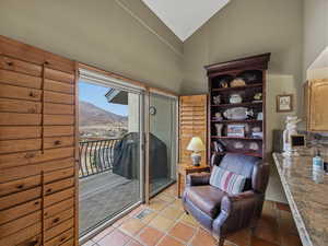 Sitting room with a mountain view and lofted ceiling