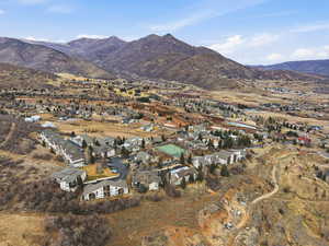 Aerial overview of property's location featuring nearby suburban area and a mountainous background