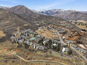 Aerial overview of property's location featuring nearby suburban area and mountains