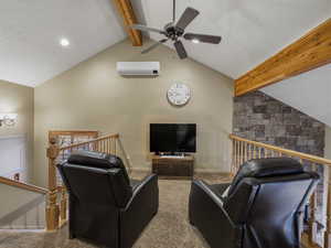 Living area featuring beam ceiling, a textured ceiling, a ceiling fan, carpet flooring, and recessed lighting