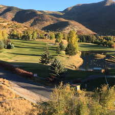 View of community with a water and mountain view and golf course view