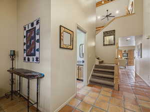 Hall with stairway and light tile patterned floors