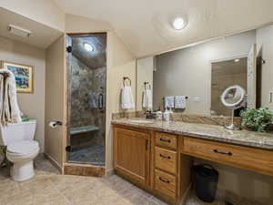 Bathroom featuring vanity, a stall shower, a textured ceiling, and light tile patterned flooring