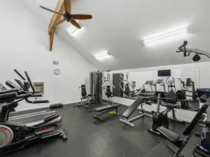 Workout area with lofted ceiling and a ceiling fan