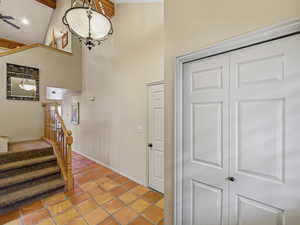 Foyer entrance with light tile patterned floors and a high ceiling