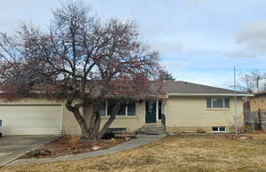 View of front of home featuring brick siding, driveway, entry steps, and an attached garage