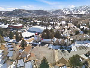 Snowy aerial view with a mountain view and a residential view