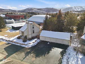 Snowy aerial view featuring a mountain view