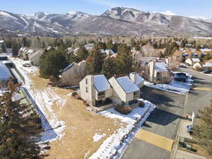 Snowy aerial view with a residential view and a mountain view