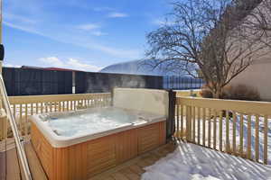 Snow covered deck with a hot tub