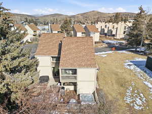 Snowy aerial view featuring a residential view and a mountain view