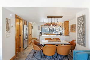 Dining room with baseboards and light tile patterned flooring