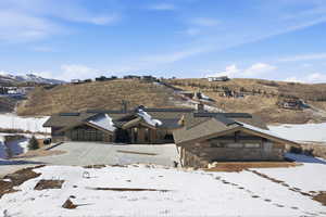 View of front of home featuring stone siding, solar panels, and a mountain view
