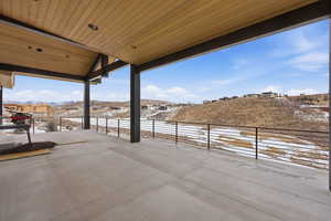 Snow covered patio with a patio area and a mountain view