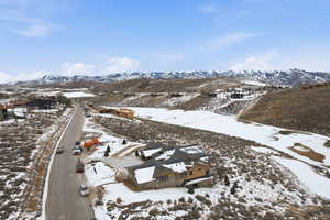 Snowy aerial view featuring a mountain view