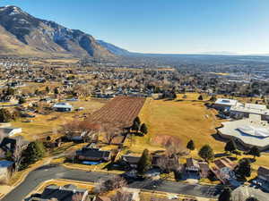 Aerial view of property's location featuring a mountain backdrop and nearby suburban area