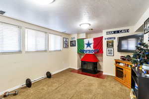 Office space featuring a textured ceiling and dark carpet