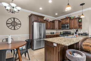 Kitchen featuring dark wood finish cabinets, open shelves, stainless steel appliances, a peninsula, and suspended lighting