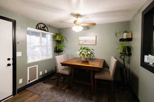 Dining space featuring a ceiling fan, a textured ceiling, and dark wood-style flooring